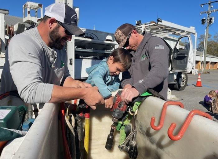 lineman and child in bucket